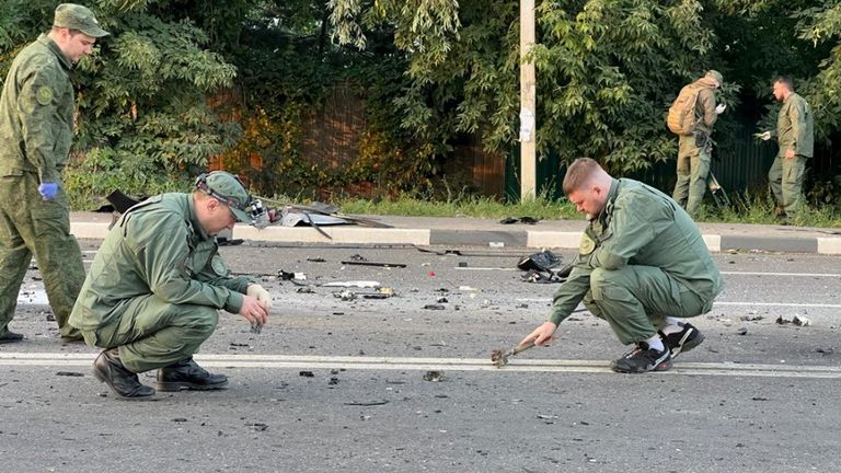 Investigators work at the site of a suspected car bomb attack that killed Darya Dugina, daughter of ultra-nationalist Russian ideologue Alexander Dugin, in the Moscow region, Russia